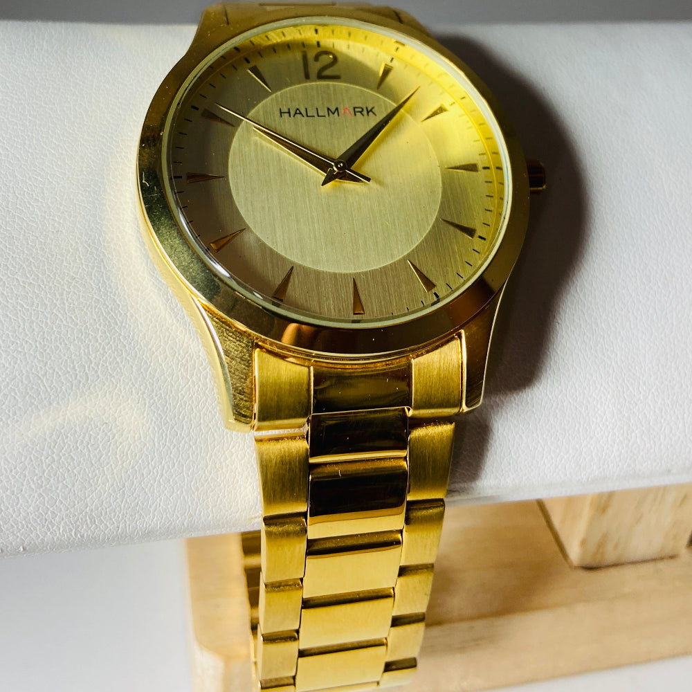 Gold watch with a detailed face on a light background. watches jewellery gold jewellery Deep Shine Jewellers