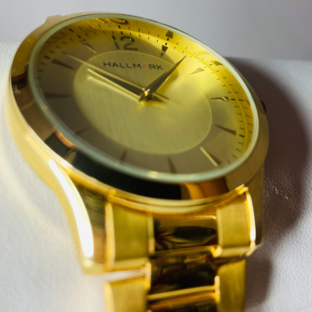 Gold watch with a detailed face on a light background. watches jewellery gold jewellery Deep Shine Jewellers