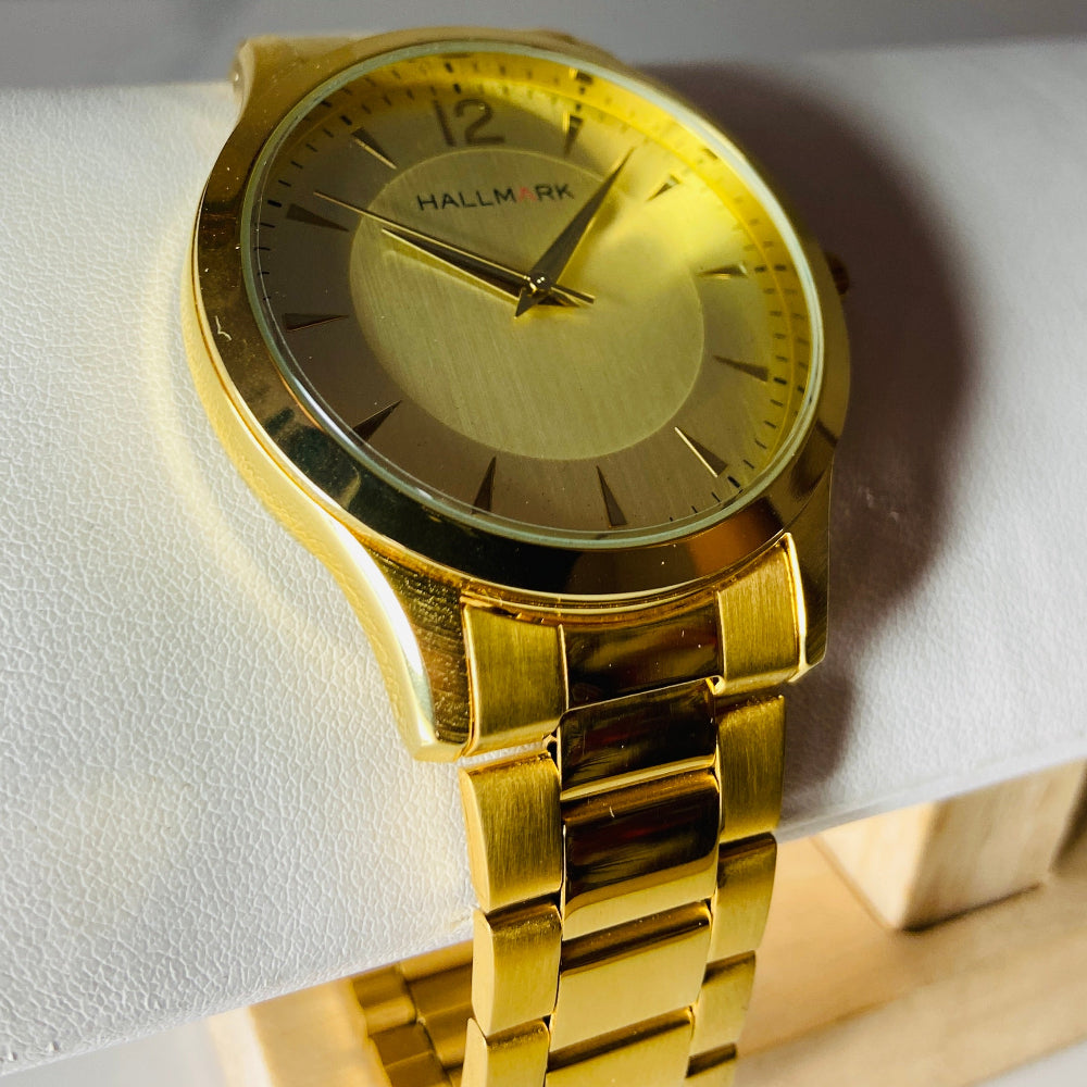 Gold watch with a detailed face on a light background. watches jewellery gold jewellery Deep Shine Jewellers