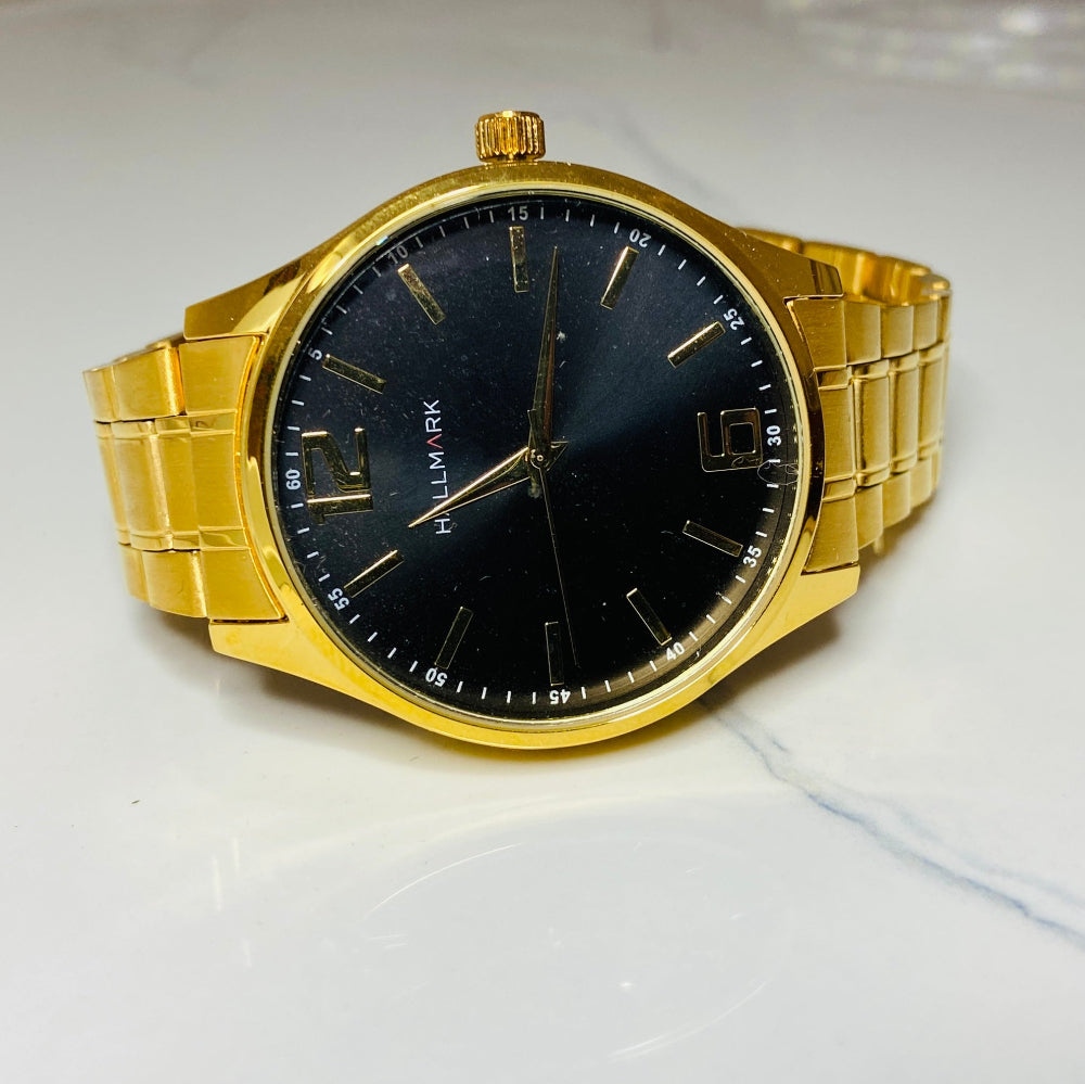 Gold wristwatch with black dial on a white cushion against a light background Gold Hallmark Watch watches mens kings DSJ Deep Shine Jewellers timeless timepiece time exclusive jewellery jewelry Your Time To Shine