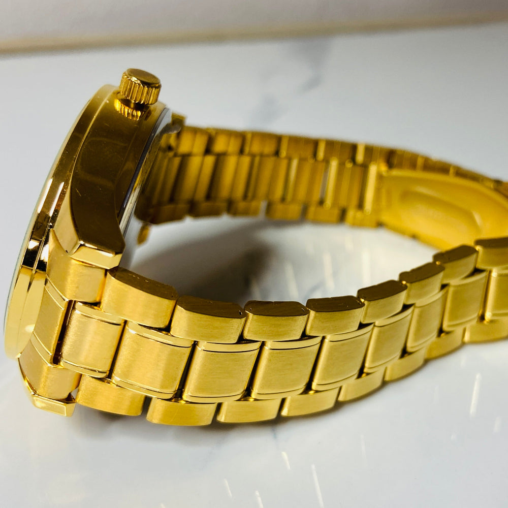 Gold metal watch strap on a white background Gold wristwatch with black dial on a white cushion against a light background Gold Hallmark Watch watches mens kings DSJ Deep Shine Jewellers timeless timepiece time exclusive jewellery jewelry Your Time To Shine