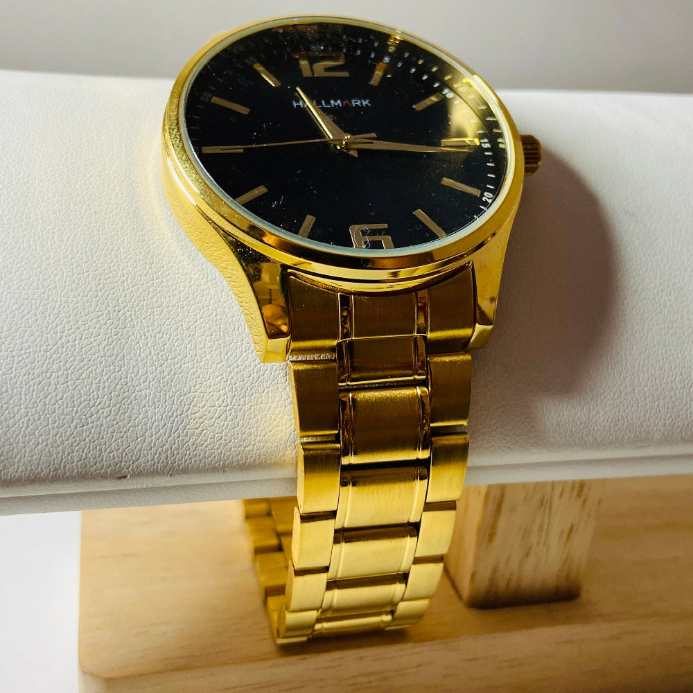 Gold wristwatch with black dial on a white cushion against a light background Gold Hallmark Watch watches mens kings DSJ Deep Shine Jewellers timeless timepiece time exclusive jewellery jewelry Your Time To Shine