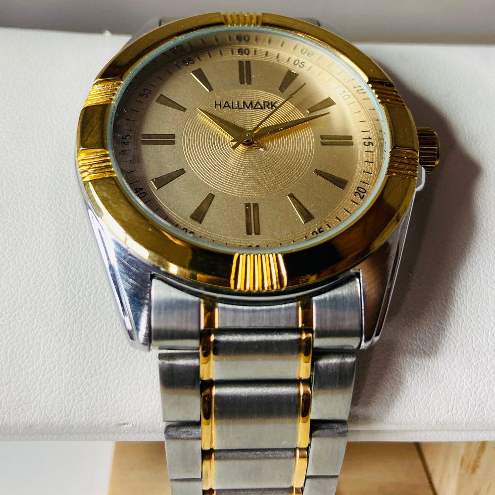 Gold and silver watch on a white cushion with a gray background jewellery watches stainless steel Deep Shine Jewellers