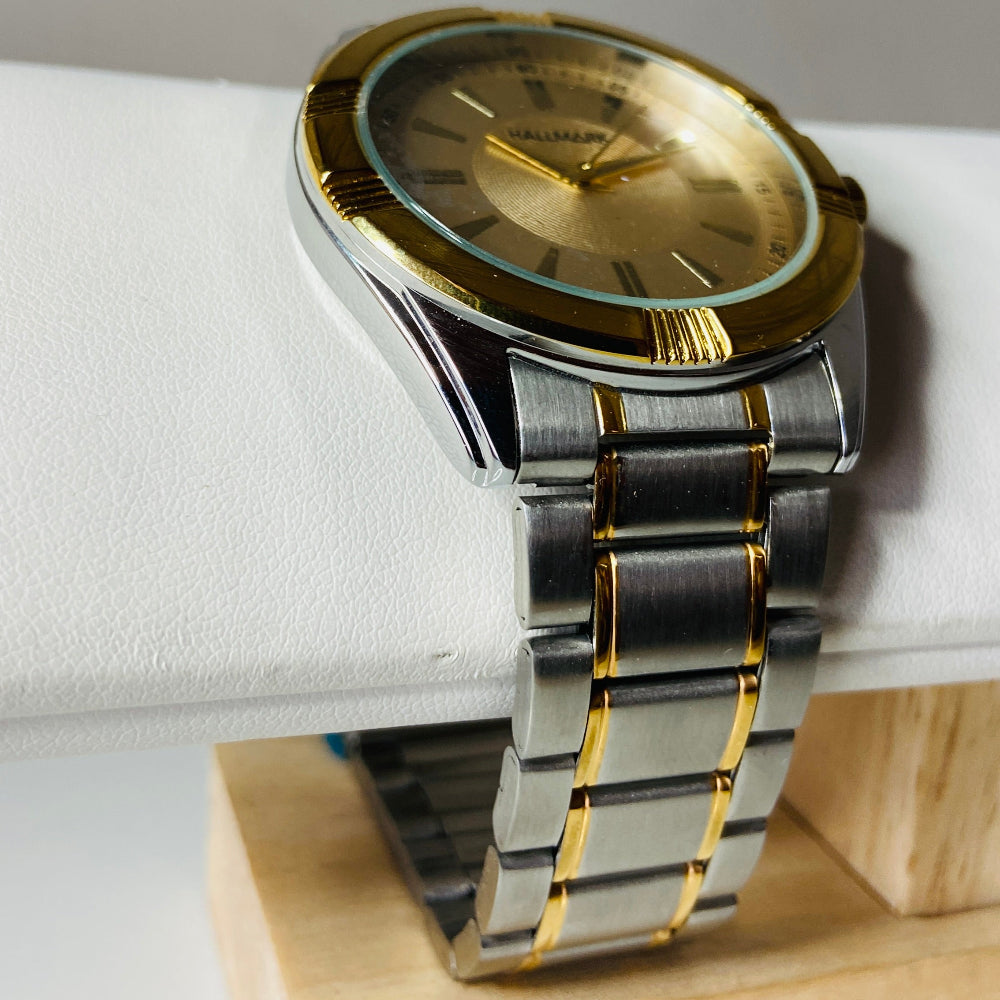 Gold and silver watch on a white cushion with a gray background jewellery watches stainless steel Deep Shine Jewellers