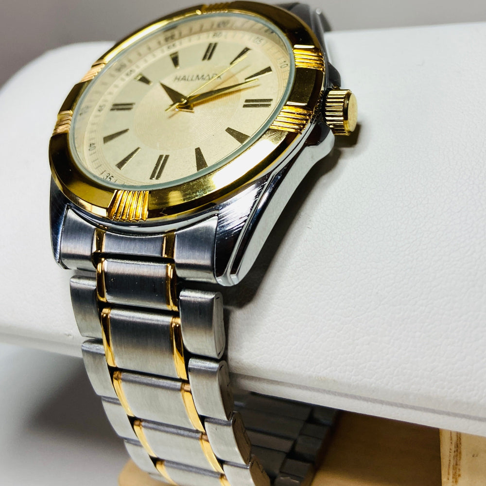 Gold and silver watch on a white cushion with a gray background jewellery watches stainless steel Deep Shine Jewellers