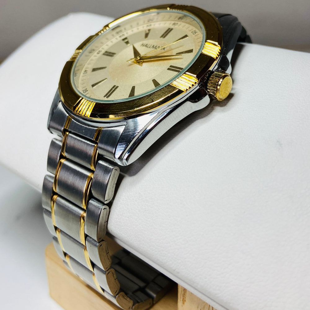 Gold and silver watch on a white cushion with a gray background jewellery watches stainless steel Deep Shine Jewellers