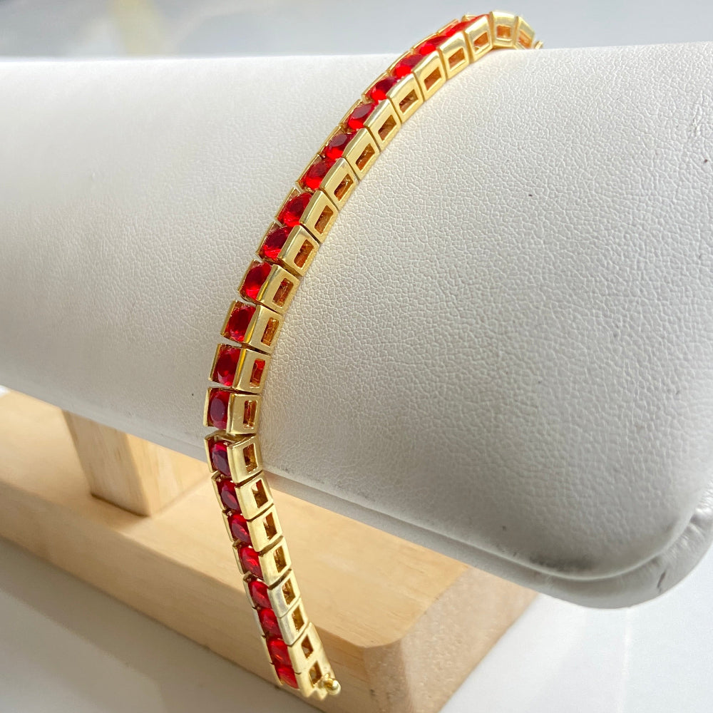 Gold bracelet with red beads on a white cushion Gold bracelet with red gemstones on a white cushion Gold red ruby bracelet women queens ladies female tennis bracelet ruby red 925 silver sterling silver gold plated golden exclusive affordable luxury jewellery jewelry Deep Shine Jewellers DSJ Your Time To Shine trending best seller buy purchase bracelets 