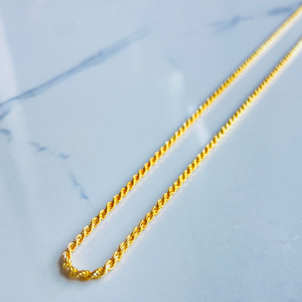 Gold chain on a marble surface gold rope chain men women ladies gents queens kings 925 silver sterling silver exclusive design affordable luxury trending pieces Deep Shine Jewellers jewellery jewelry gold plated golden Your Time To Shine DSJ quality premium beauty