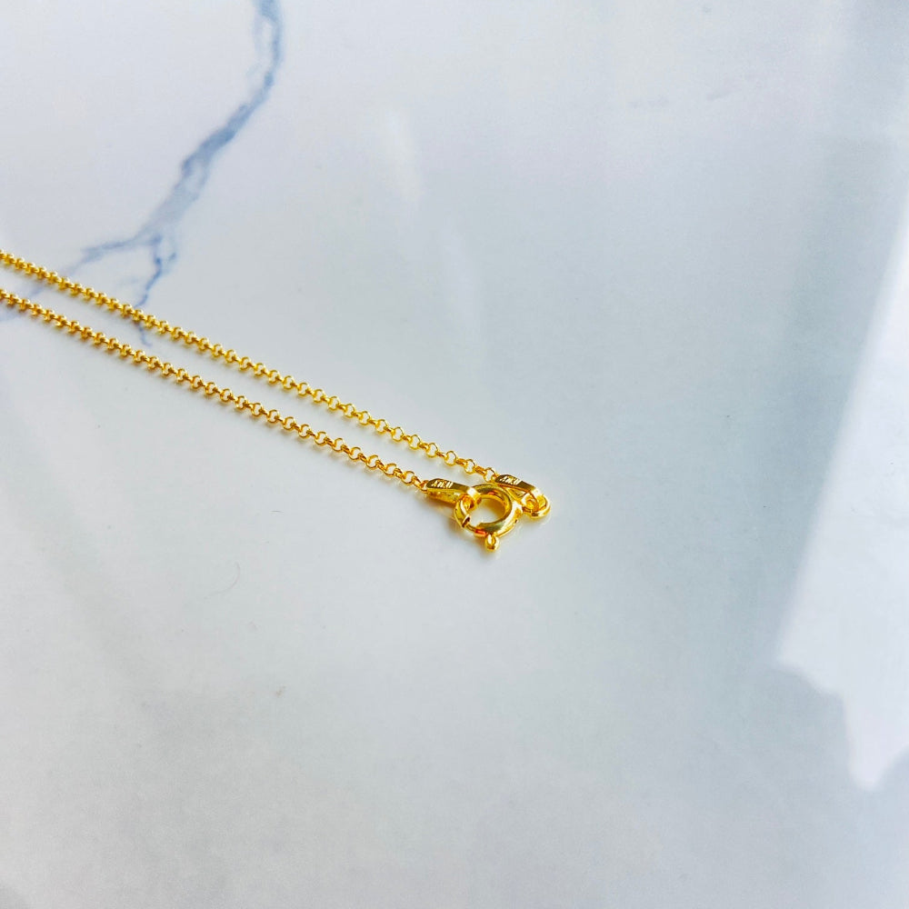 Gold necklace on a marble surface Gold chain necklace on a light gray textured background gold belcher chain women ladies queens gold plated golden 925 silver sterling silver affordable luxury premium jewelllery jewelry high quality trending shop now best selling Deep Shine Jewellers Your Time To Shine DSJ store 