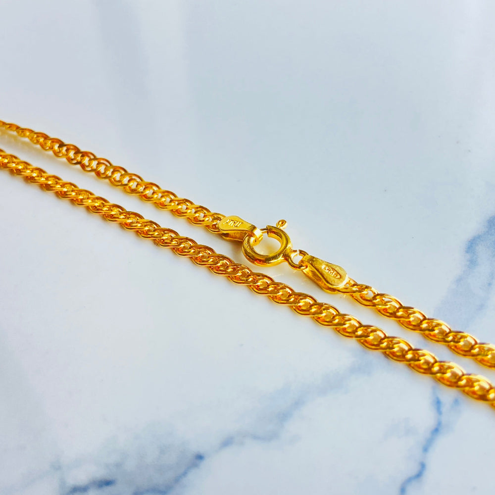 Gold chain necklace on a light blue background gold fancy chain necklace women ladies queen 925 silver sterling silver gold plate golden best seller trending buy now premium jewellery jewelry high quality exclusive craftsmanship Deep Shine Jewellers DSJ Your Time To Shine online store 