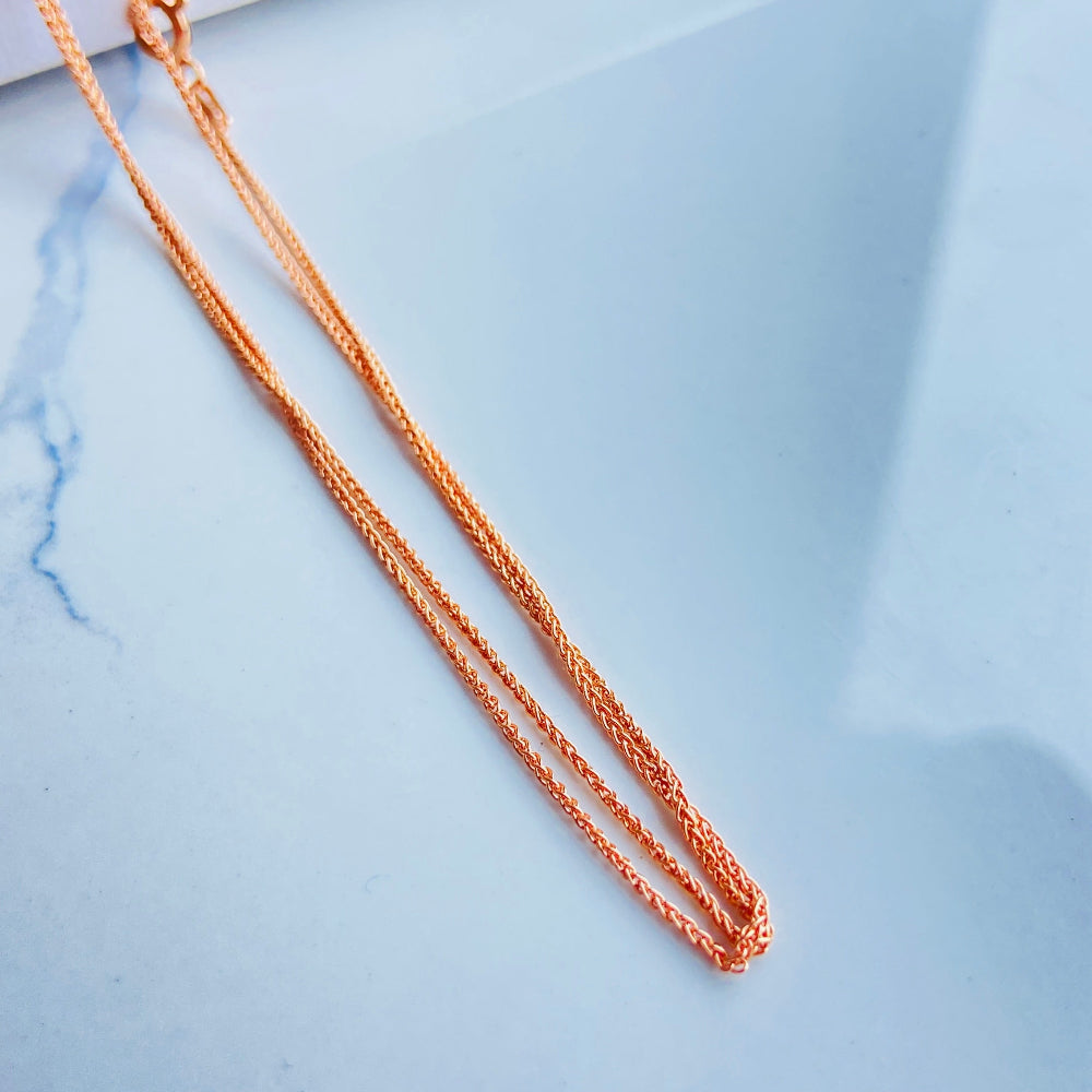 Rose gold necklace on a light blue marble surface rose gold wheat chain necklace women ladies queens 925 silver sterling silver rose gold plating roses premium jewellery jewelry affordable luxury elegant best seller trending Deep Shine Jewellers DSJ Your Time To Shine