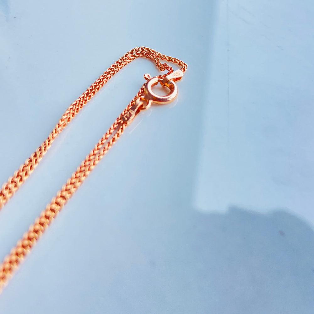 Rose gold necklace on a light blue background Rose gold necklace on a light blue marble surface rose gold wheat chain necklace women ladies queens 925 silver sterling silver rose gold plating roses premium jewellery jewelry affordable luxury elegant best seller trending Deep Shine Jewellers DSJ Your Time To Shine