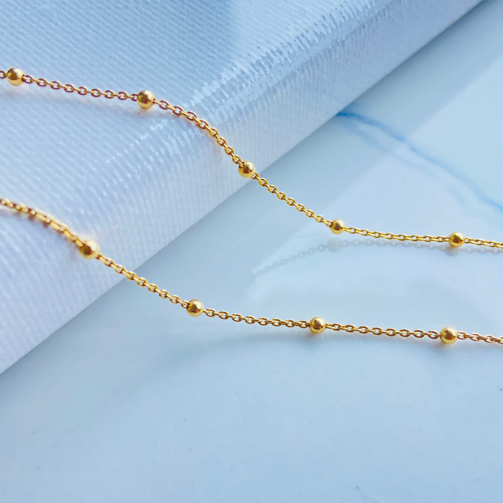 Gold chain necklace on a light blue fabric background Gold chain necklace on a marble surface Gold ball linked cable chain necklaces women ladies queen gold plated golden 925 silver sterling silver premium jewellery jewelry affordable luxury best selling trending beauty Deep Shine Jewellery DSJ Your Time To Shine Cape Town exclusive craftsmaship South Africa ball and cable link 