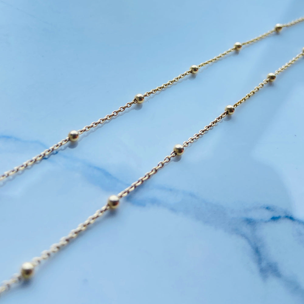 Gold necklace on a light blue marble surface Gold chain necklace on a marble surface Gold ball linked cable chain necklaces women ladies queen gold plated golden 925 silver sterling silver premium jewellery jewelry affordable luxury best selling trending beauty Deep Shine Jewellery DSJ Your Time To Shine Cape Town exclusive craftsmaship South Africa ball and cable link 