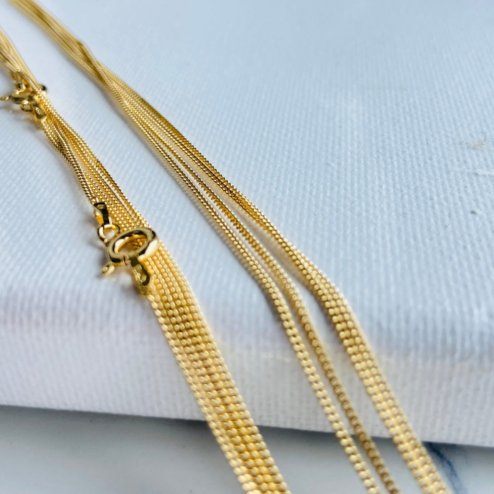 Gold chain on a light blue background gold micro flat curb chain necklace gold plated golden 925 silver sterling silver precious metals premium jewellery jewelry affordable luxury women mens gents ladies queens kings exclusive craftsmanship Deep Shine Jewellery DSJ Your Time To Shine trending best sellers kingdom