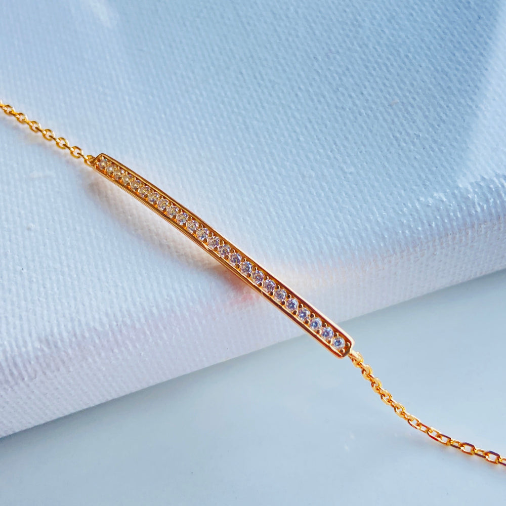 Gold bracelet with small diamonds on a white fabric background rose gold ice strip bracelet women ladies queens 925 silver sterling premium jewellery jewelry affordable luxury Deep Shine Jewellers exclusive craftsmanship best sellers trending christmas gifts Your Time To Shine DSJ Cape Town rose gold plating 