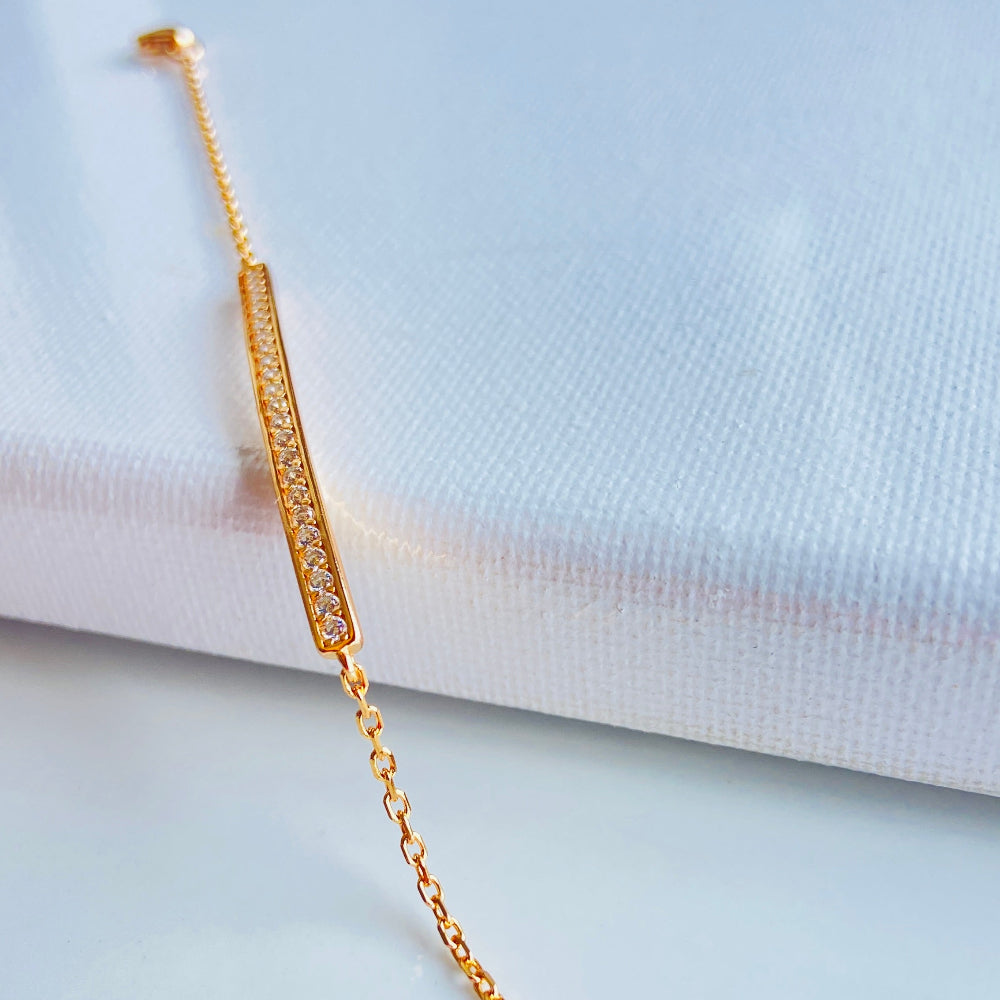 Gold bracelet with small diamonds on a white fabric background rose gold ice strip bracelet women ladies queens 925 silver sterling premium jewellery jewelry affordable luxury Deep Shine Jewellers exclusive craftsmanship best sellers trending christmas gifts Your Time To Shine DSJ Cape Town rose gold plating 