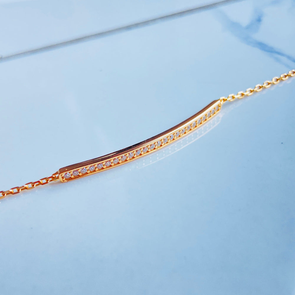 Gold necklace with small diamonds on a light blue surface Gold bracelet with small diamonds on a white fabric background rose gold ice strip bracelet women ladies queens 925 silver sterling premium jewellery jewelry affordable luxury Deep Shine Jewellers exclusive craftsmanship best sellers trending christmas gifts Your Time To Shine DSJ Cape Town rose gold plating 