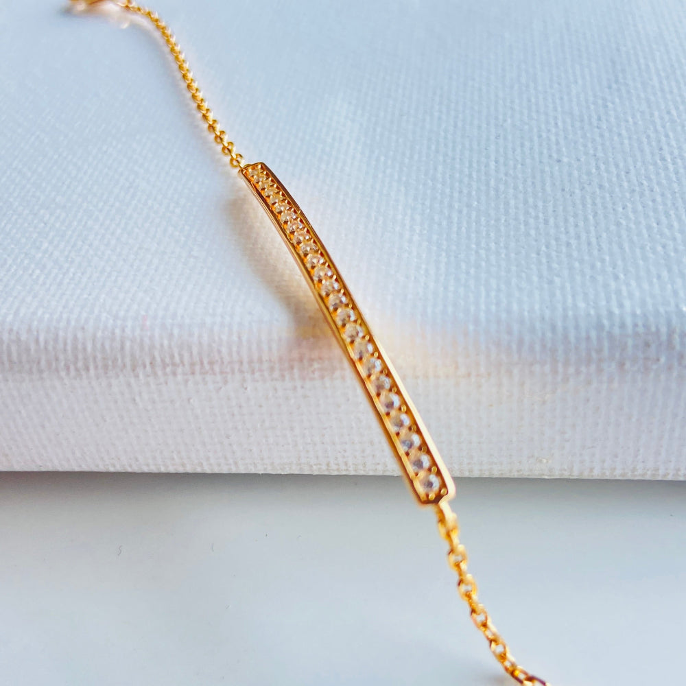 Gold bracelet on a light blue background Gold bracelet with small diamonds on a white fabric background rose gold ice strip bracelet women ladies queens 925 silver sterling premium jewellery jewelry affordable luxury Deep Shine Jewellers exclusive craftsmanship best sellers trending christmas gifts Your Time To Shine DSJ Cape Town rose gold plating 