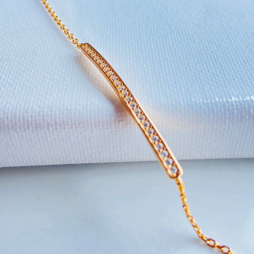 Gold bracelet with engraved design on a light blue fabric background Gold bracelet with small diamonds on a white fabric background rose gold ice strip bracelet women ladies queens 925 silver sterling premium jewellery jewelry affordable luxury Deep Shine Jewellers exclusive craftsmanship best sellers trending christmas gifts Your Time To Shine DSJ Cape Town rose gold plating 