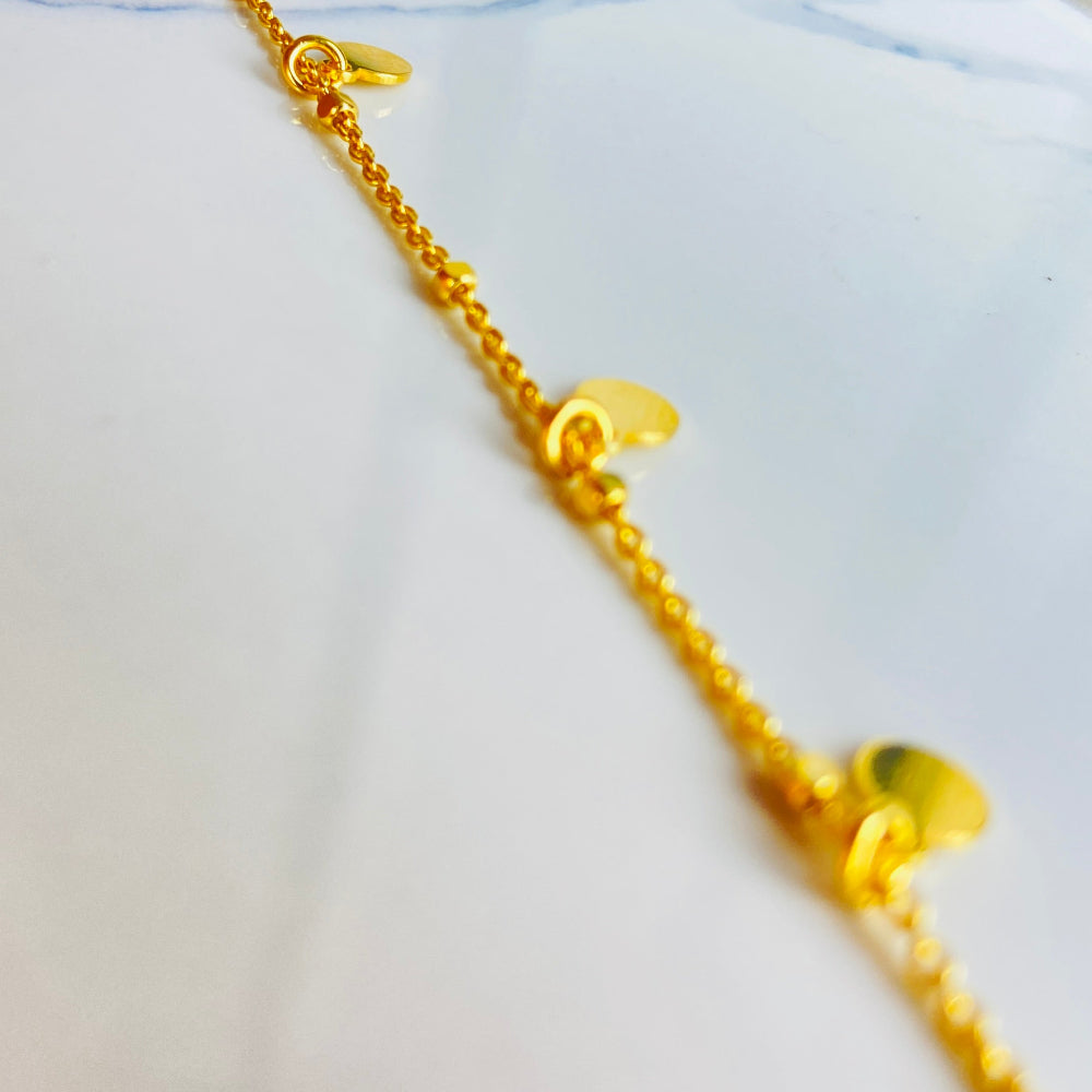 Gold chain bracelet on a light blue fabric background Shine Bright with Deep Shine Jewellers Exclusive Gold Circle and Chain Bracelet women ladies queens 925 silver sterling silver gold plated golden premium jewellery jewelry affordable luxury best sellers trending christmas gifts loved ones Your Time To Shine DSJ exclusive craftsmanship 