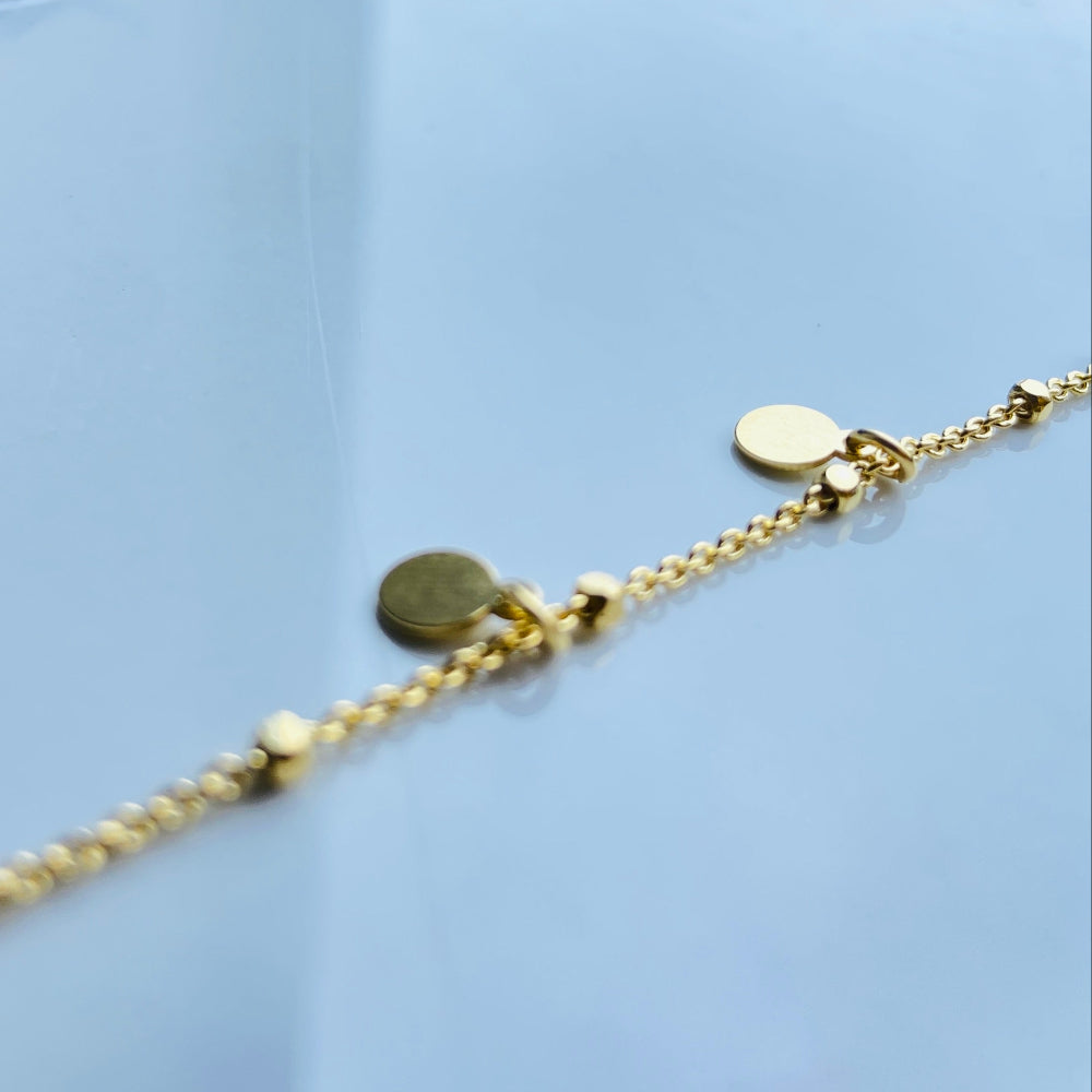 Gold bracelet on a light blue surface Gold chain bracelet on a light blue fabric background Shine Bright with Deep Shine Jewellers Exclusive Gold Circle and Chain Bracelet women ladies queens 925 silver sterling silver gold plated golden premium jewellery jewelry affordable luxury best sellers trending christmas gifts loved ones Your Time To Shine DSJ exclusive craftsmanship 