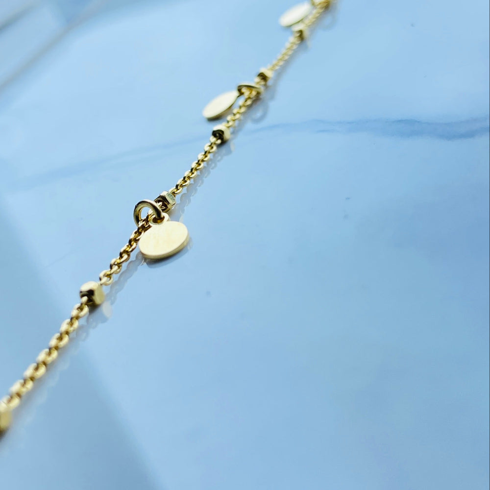 Gold necklace with heart pendants on a light blue background Gold chain bracelet on a light blue fabric background Shine Bright with Deep Shine Jewellers Exclusive Gold Circle and Chain Bracelet women ladies queens 925 silver sterling silver gold plated golden premium jewellery jewelry affordable luxury best sellers trending christmas gifts loved ones Your Time To Shine DSJ exclusive craftsmanship 
