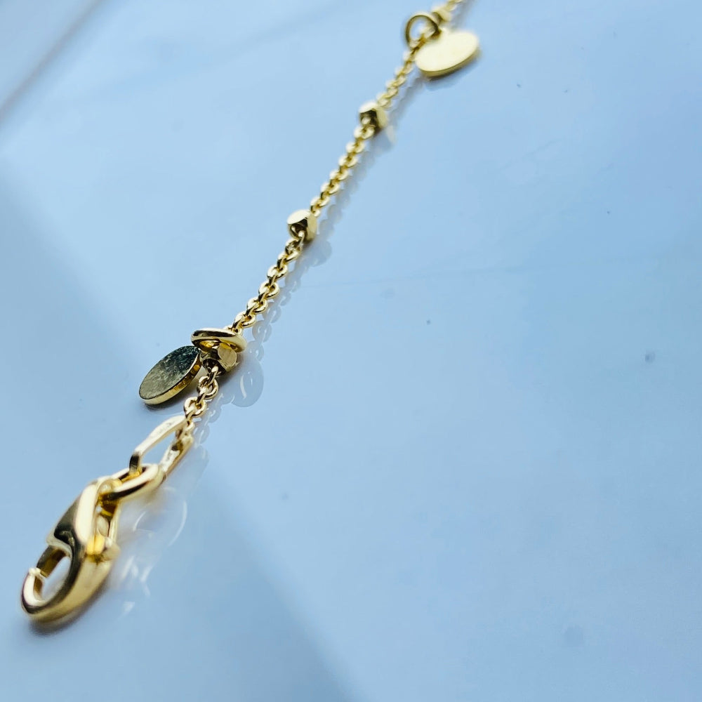 Gold necklace with a heart pendant on a light blue background Gold chain bracelet on a light blue fabric background Shine Bright with Deep Shine Jewellers Exclusive Gold Circle and Chain Bracelet women ladies queens 925 silver sterling silver gold plated golden premium jewellery jewelry affordable luxury best sellers trending christmas gifts loved ones Your Time To Shine DSJ exclusive craftsmanship 