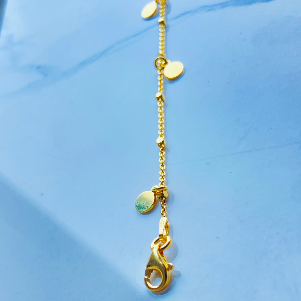 Gold necklace with a pendant on a light blue background Gold chain bracelet on a light blue fabric background Shine Bright with Deep Shine Jewellers Exclusive Gold Circle and Chain Bracelet women ladies queens 925 silver sterling silver gold plated golden premium jewellery jewelry affordable luxury best sellers trending christmas gifts loved ones Your Time To Shine DSJ exclusive craftsmanship 