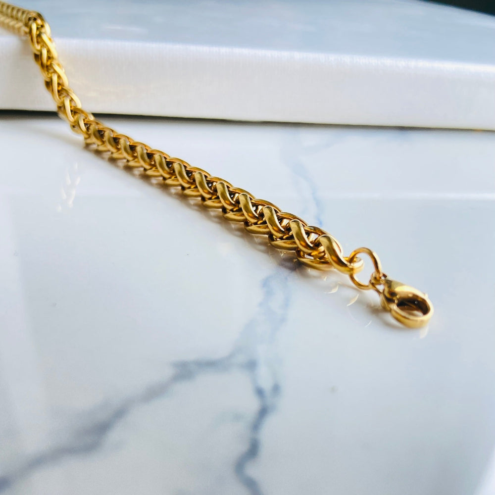Gold chain bracelet on a marble surface gold wheat bracelet womens mens ladies gents queens kings stainless steel gold plated golden exclusive craftsmanship affordable luxury premium jewellery jewelry cape town design Deep Shine Jewellers DSJ Your Time To Shine best sellers online store vault trending sales 