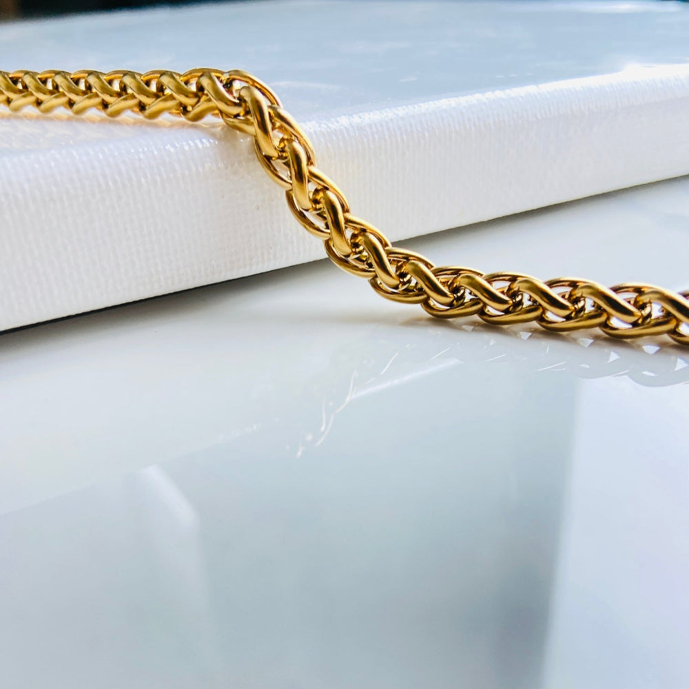Gold chain bracelet on a marble surface gold wheat bracelet womens mens ladies gents queens kings stainless steel gold plated golden exclusive craftsmanship affordable luxury premium jewellery jewelry cape town design Deep Shine Jewellers DSJ Your Time To Shine best sellers online store vault trending sales 
