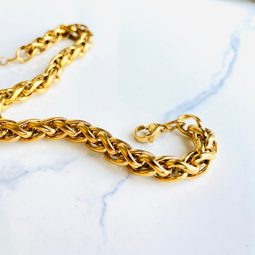 Gold chain necklace on a marble surface Gold chain bracelet on a marble surface gold wheat bracelet womens mens ladies gents queens kings stainless steel gold plated golden exclusive craftsmanship affordable luxury premium jewellery jewelry cape town design Deep Shine Jewellers DSJ Your Time To Shine best sellers online store vault trending sales 