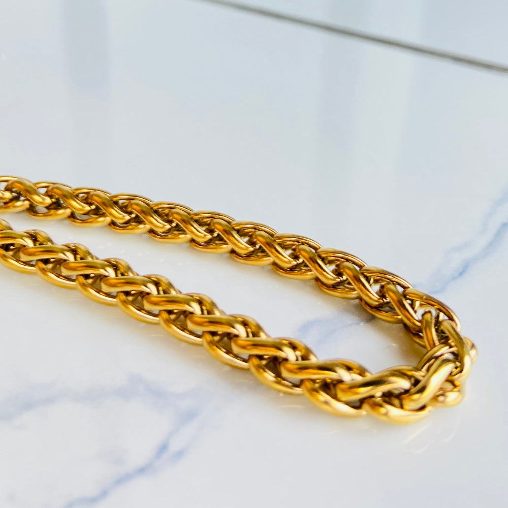 Gold chain on a light marble background Gold chain bracelet on a marble surface gold wheat bracelet womens mens ladies gents queens kings stainless steel gold plated golden exclusive craftsmanship affordable luxury premium jewellery jewelry cape town design Deep Shine Jewellers DSJ Your Time To Shine best sellers online store vault trending sales 