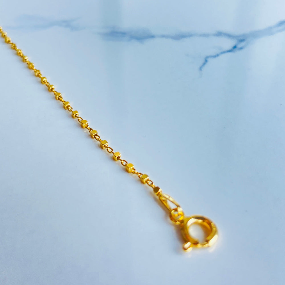 Gold necklace chain on a light blue marble surface Gold chain on a light blue marble surface gold block bead bracelet women ladies queens gold plated golden 925 silver sterling silver buy now exclusive craftsmanship affordable luxury best sellers trending beauty premium quality jewellery jewelry Deep Shine Jewellers Your Time To Shine DSJ shop now 