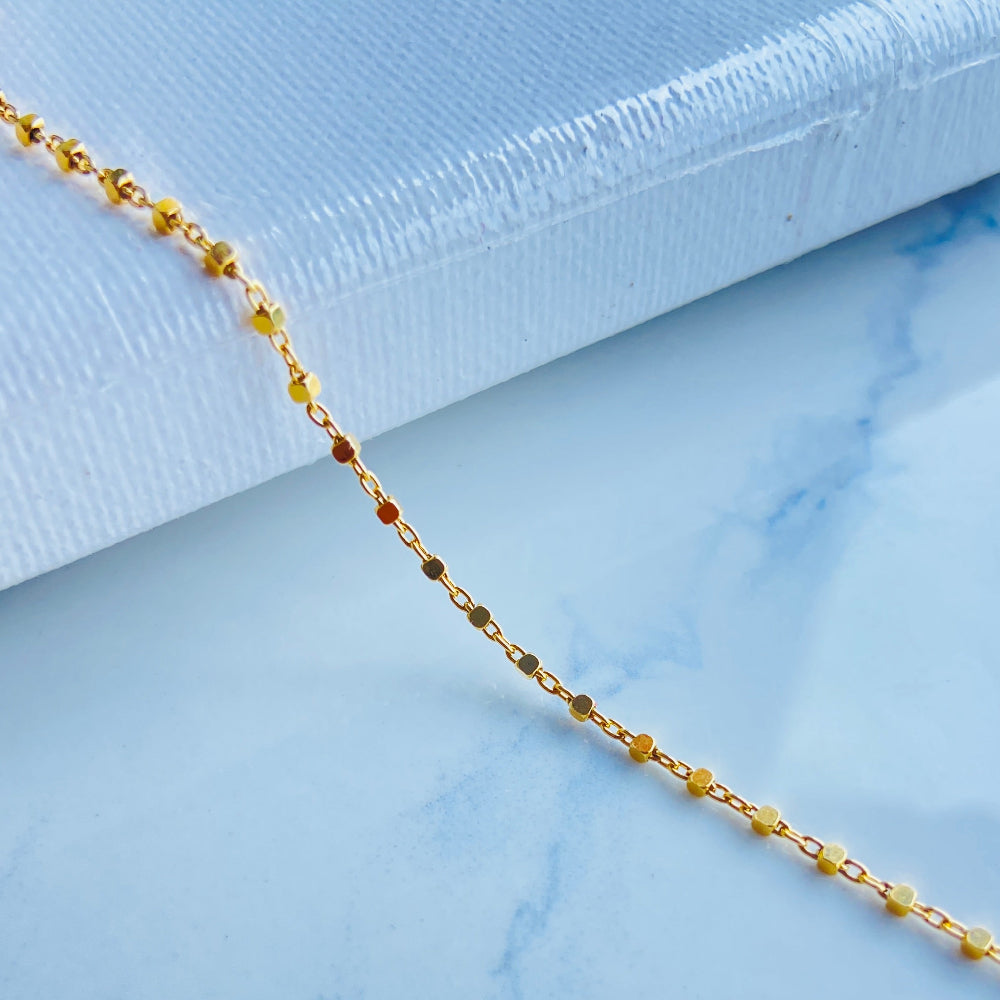 Gold chain on a light blue marble surface gold block bead bracelet women ladies queens gold plated golden 925 silver sterling silver buy now exclusive craftsmanship affordable luxury best sellers trending beauty premium quality jewellery jewelry Deep Shine Jewellers Your Time To Shine DSJ shop now 