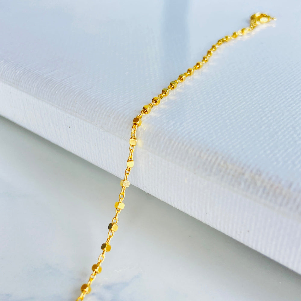 Gold bracelet on a marble surface with a white fabric background Gold chain on a light blue marble surface gold block bead bracelet women ladies queens gold plated golden 925 silver sterling silver buy now exclusive craftsmanship affordable luxury best sellers trending beauty premium quality jewellery jewelry Deep Shine Jewellers Your Time To Shine DSJ shop now 