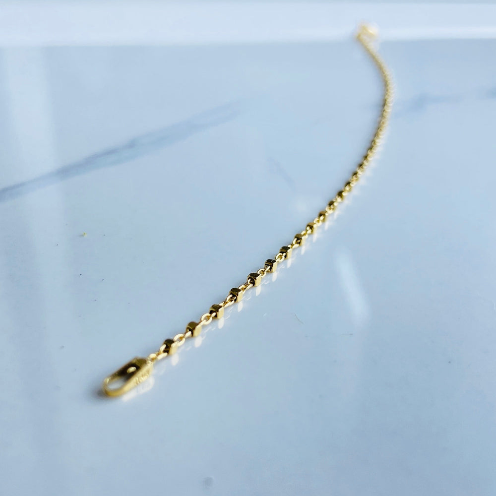 Gold chain with a clasp on a white surface Gold chain on a light blue marble surface gold block bead bracelet women ladies queens gold plated golden 925 silver sterling silver buy now exclusive craftsmanship affordable luxury best sellers trending beauty premium quality jewellery jewelry Deep Shine Jewellers Your Time To Shine DSJ shop now 