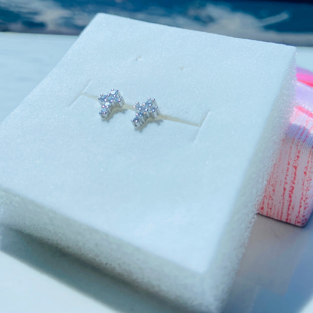 Diamond earrings in a jewelry box with a blurred background Silver earrings on a white card with a pink bow in the background silver ice cross stud earring women men ladies gents queens kings 925 silver sterling silver exclusive affordable luxury jewellery jewelry Deep Shine Jewellers trending. shop now best sellers elegant DSJ Your Time To Shine