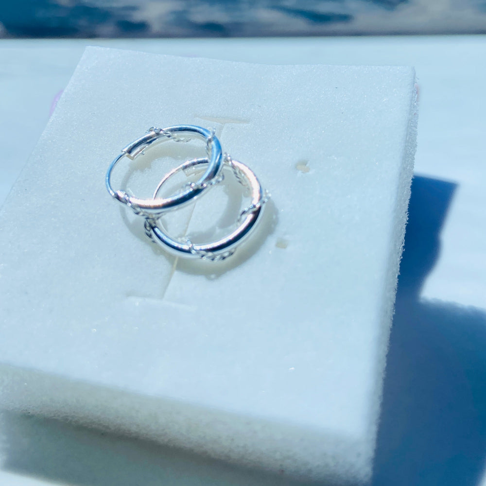 Silver ring on a white cushion with a blue background Silver hoop earrings on a white box with a pink ribbon silver twisted sleeper hoop earrings for men women ladies gents queens kings 925 silver sterling silver premium quality exclusive craftsmanship Deep Shine Jewellers jewellery jewelry affordable luxury Your Time To Shine DSJ