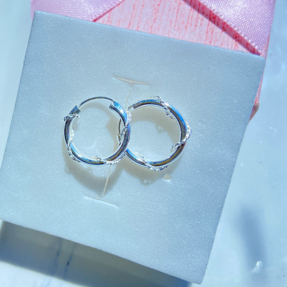 Silver hoop earrings on a white box with a pink ribbon silver twisted sleeper hoop earrings for men women ladies gents queens kings 925 silver sterling silver premium quality exclusive craftsmanship Deep Shine Jewellers jewellery jewelry affordable luxury Your Time To Shine DSJ
