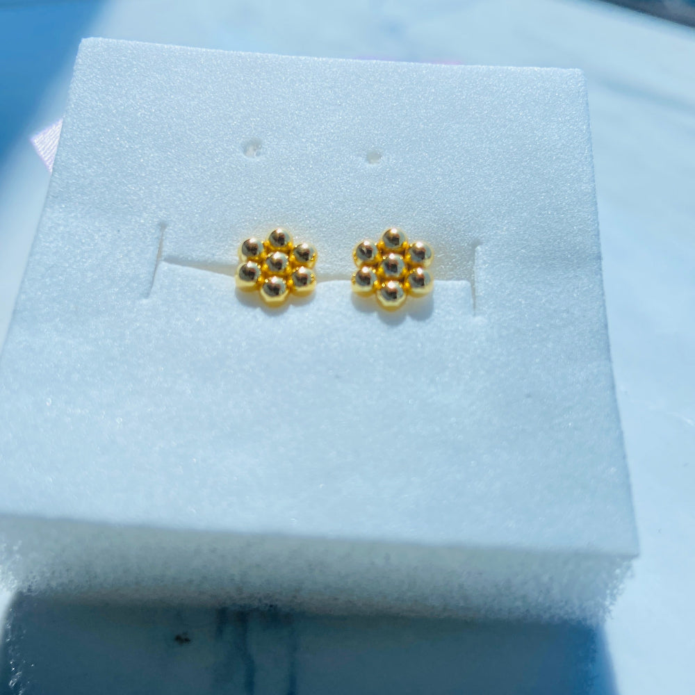 Gold earrings in a white jewelry box on a reflective surface Gold earrings with gemstones on a white stand against a blue background gold round bee hive earring for men women ladies gents kings queens 925 silver sterling silver gold plated golden exclusive craftsmanship Deep Shine Jewellers jewellery jewelry Your Time To Shine DSJ Trending Shop now
