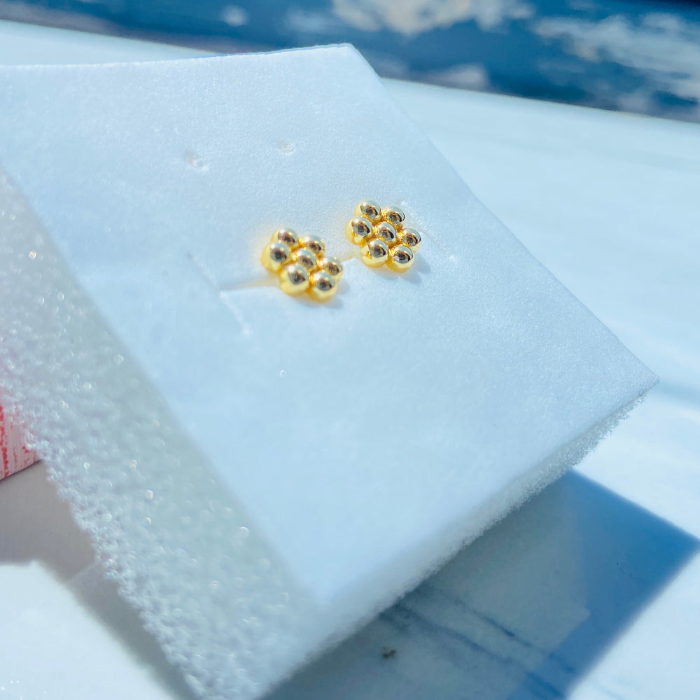 Gold earrings on a white card with a blue background Gold earrings with gemstones on a white stand against a blue background gold round bee hive earring for men women ladies gents kings queens 925 silver sterling silver gold plated golden exclusive craftsmanship Deep Shine Jewellers jewellery jewelry Your Time To Shine DSJ Trending Shop now