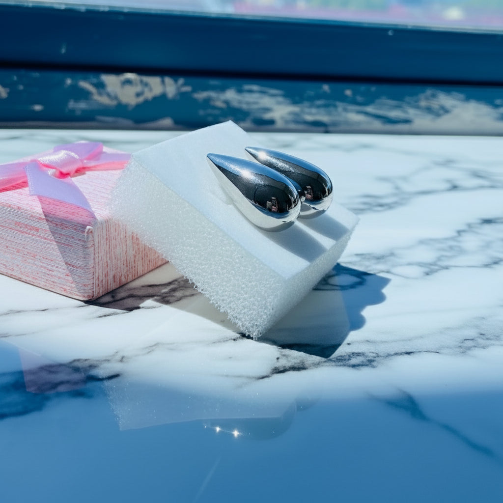 Silver earrings on a white stand with a blurred outdoor background silver drop form earrings for women ladies queens silver 925 silver sterling silver exclusive jewellery jewelry by Deep Shine Jewellers Your Time To Shine DSJ shinning beauty