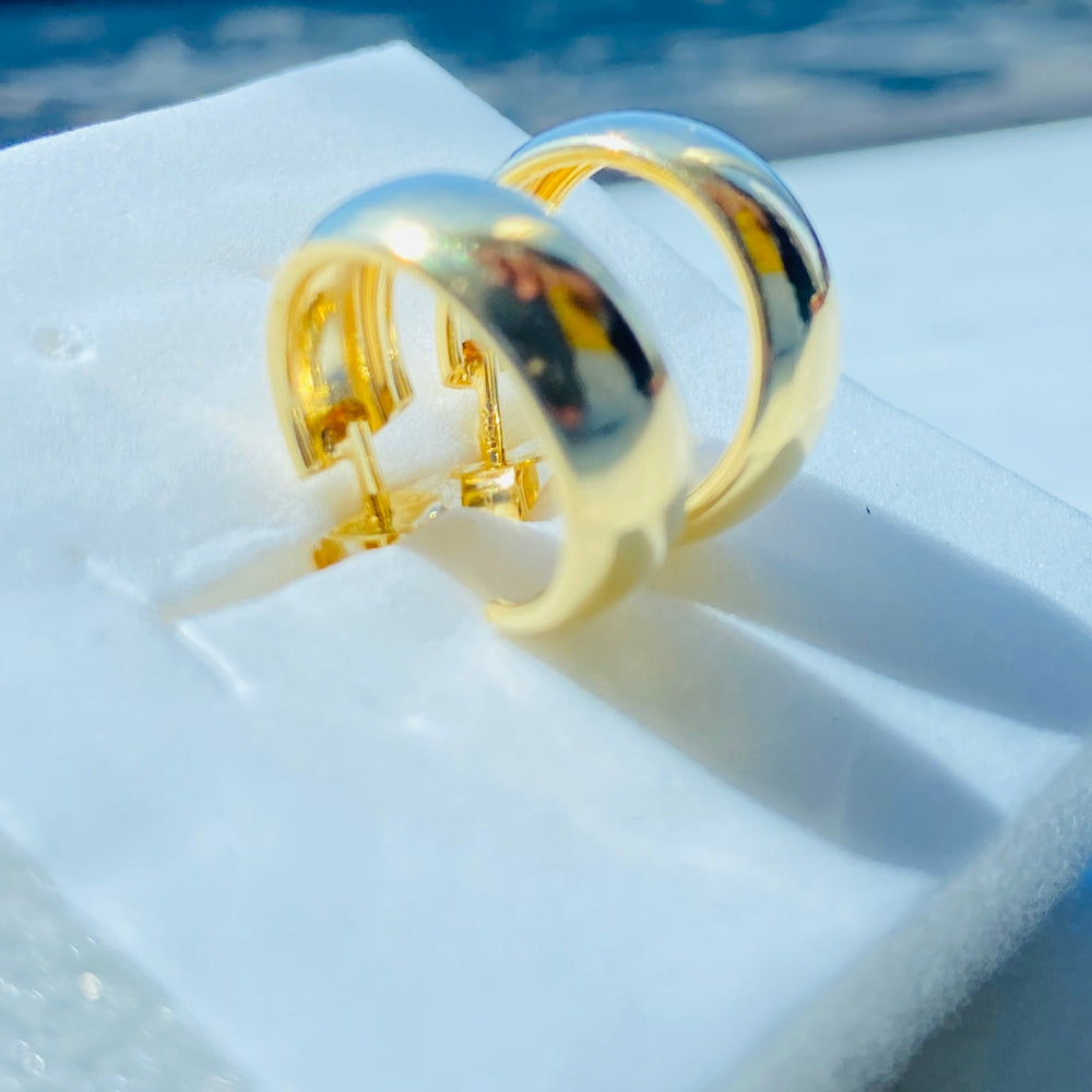 Gold ring on a white surface with a blue background Gold ring on a white surface with a blue background thick gold sleeper hoop earrings women ladies queens exclusive affordable luxury Deep Shine Jewellers jewellery jewelry gold plated 925 silver sterling silver Your Time To Shine DSJ craftsmanship trending shop now