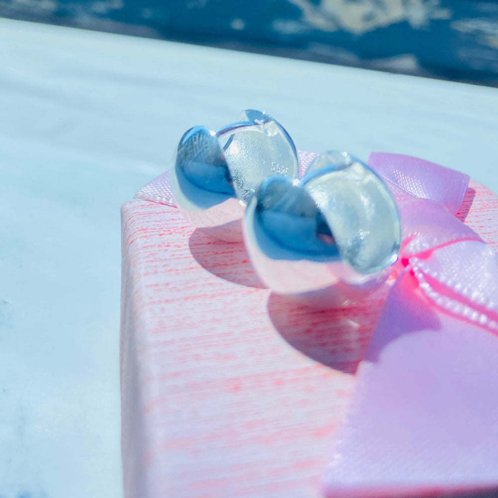 Close-up of a dental model with clear braces on a blue background Silver earrings on a white surface with a blurred background silver dome earrings women ladies queens 925 silver sterling silver craftsmanship exclusive Deep Shine Jewellers jewellery jewelry Your Time To Shine elegant shop now trending