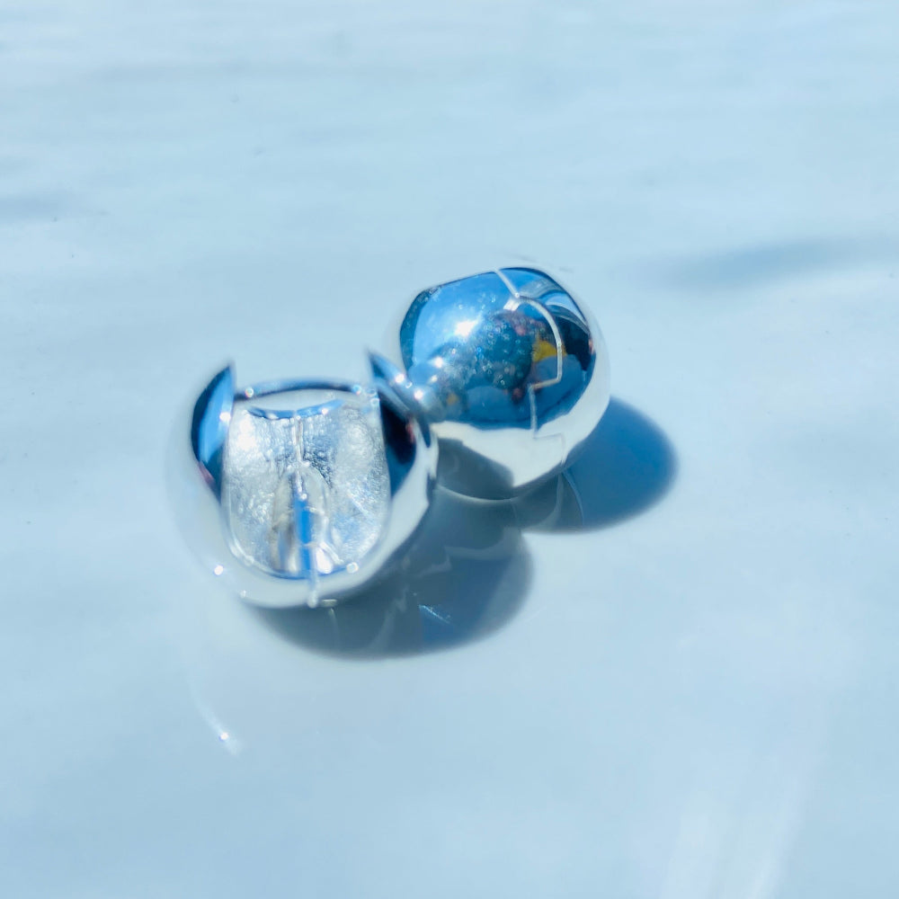 Silver earrings on a white surface with a blurred background silver dome earrings women ladies queens 925 silver sterling silver craftsmanship exclusive Deep Shine Jewellers jewellery jewelry Your Time To Shine elegant shop now trending