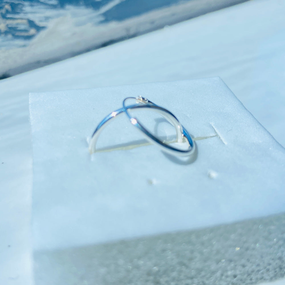 Silver ring on a white cloth with a snowy outdoor background Two silver rings on a light blue fabric surface silver sleeper hoop earrings for king queen womens mens 925 silver sterling silver exclusive Deep Shine Jewellers jewellery jewelry Your Time To Shine shop now DSJ affordable luxury high quality