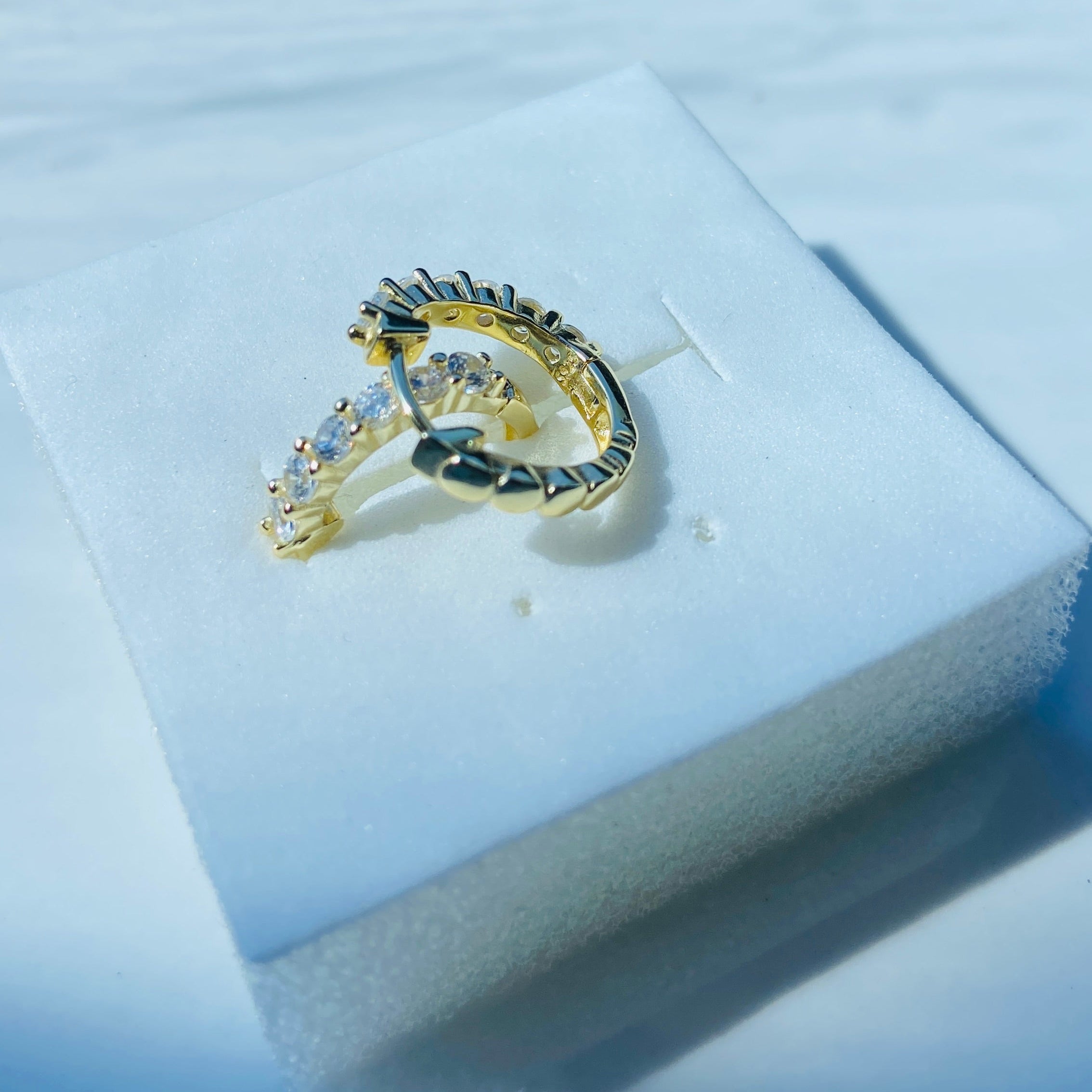 Gold and black ring on a white box with a blurred background Gold ring with diamonds on a white box Gold silver ice sleeper hoop earring yellow gold 925 silver sterling silver womens ladies queens shine bright exclusive Deep Shine Jewellers jewellery jewelry DSJ Your Time To Shine affordable luxury trendy best beauty diamonds cubic zirconia