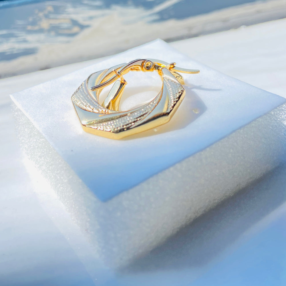 Gold hoop earrings on a white cushion with a blue background Gold Detailed Octagon Earrings jewellery jewelry stainless steel gold plated earrings queens ladies womens Deep Shine Jewellers Your Time To Shine Affordable luxury DSJ