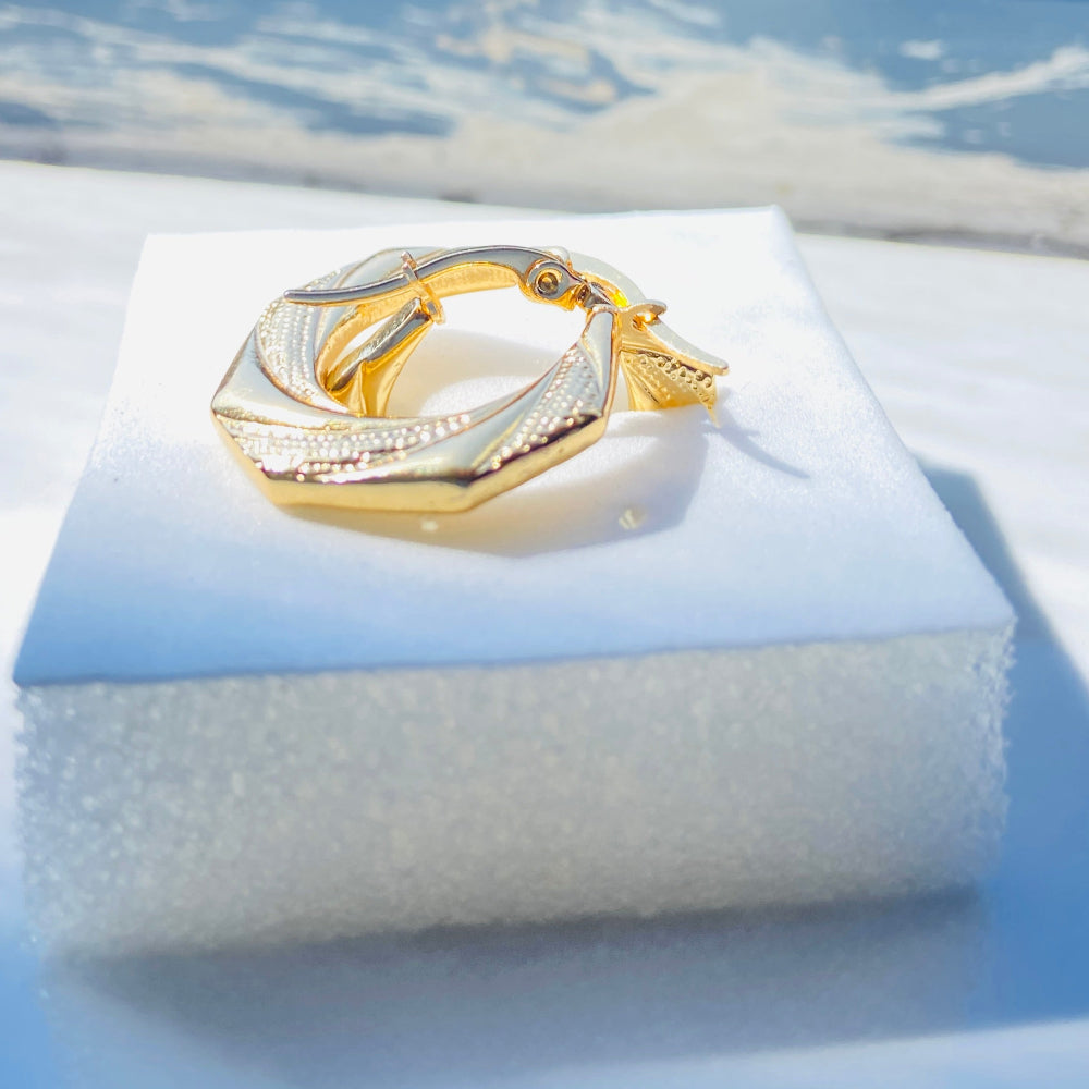 Gold ring on a white cushion with a blue background Gold Detailed Octagon Earrings jewellery jewelry stainless steel gold plated earrings queens ladies womens Deep Shine Jewellers Your Time To Shine Affordable luxury DSJ